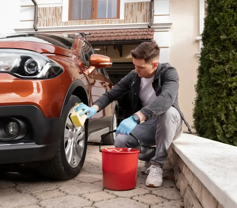 Lavage auto à domicile Cesny-les-Sources : professionnel intervenant sur un véhicule